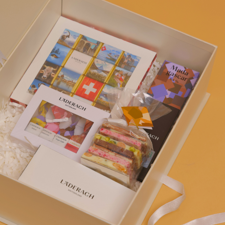 Assorted Pralines and Truffles (8 pieces) + Assorted FrischSchoggi (250 grams) + Assorted Tartufi (4 pieces) + Tablet (1 Piece) + Popcorn (1 Piece) + Deck of cards (2)